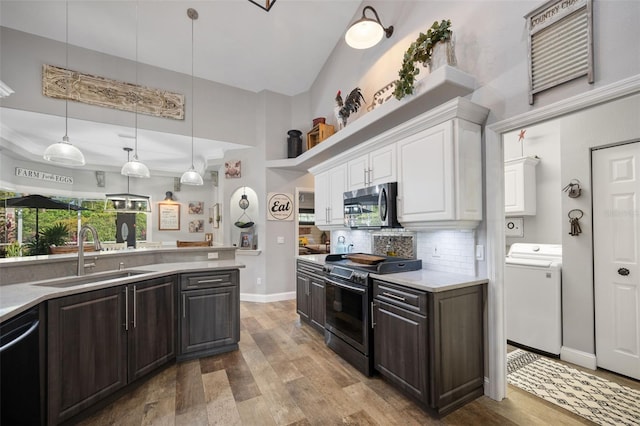 kitchen with washer / clothes dryer, stainless steel appliances, dark brown cabinets, white cabinetry, and a sink