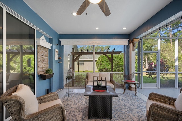 sunroom / solarium featuring a ceiling fan