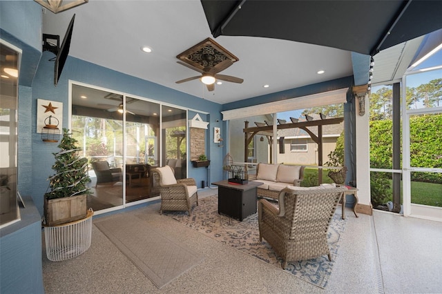 sunroom with a ceiling fan