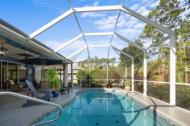 pool featuring a lanai and a patio area