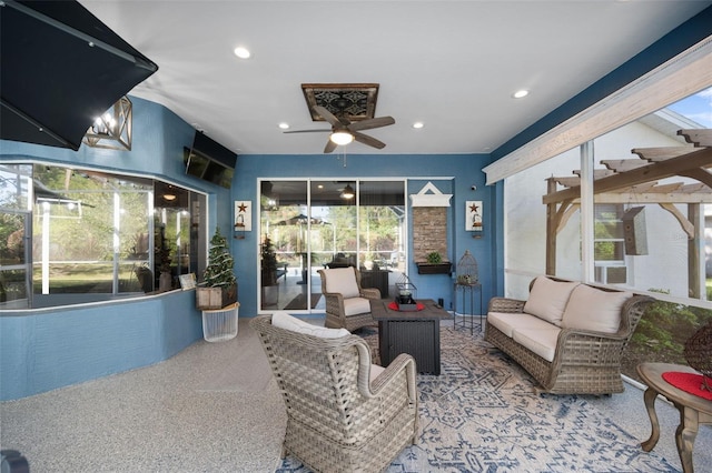 view of patio / terrace featuring a ceiling fan, glass enclosure, and outdoor lounge area