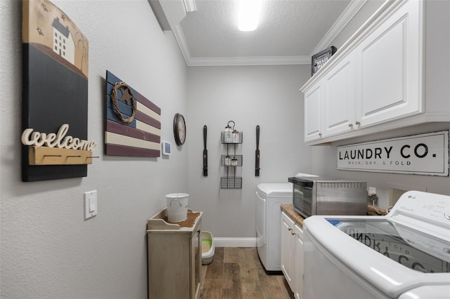 washroom featuring dark wood-style flooring, crown molding, cabinet space, washing machine and dryer, and a textured ceiling