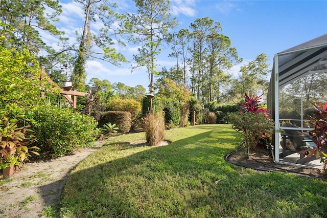 view of yard featuring glass enclosure