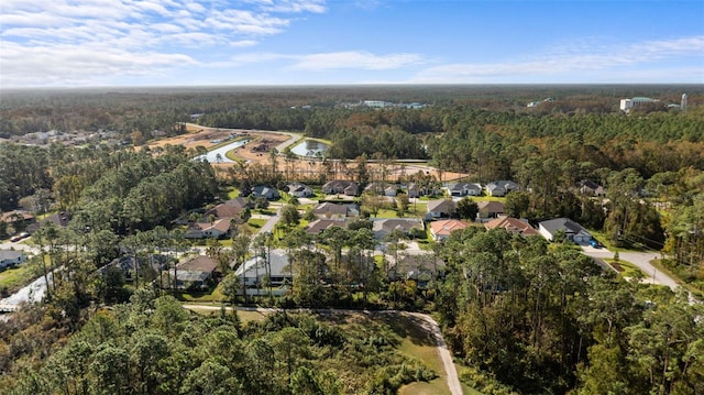 drone / aerial view with a residential view and a wooded view