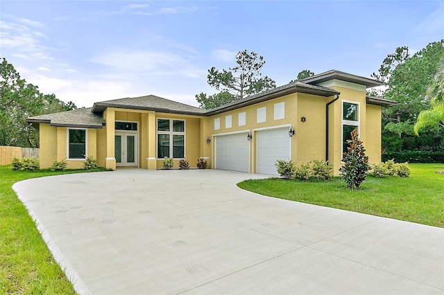 prairie-style home with a garage and a front yard