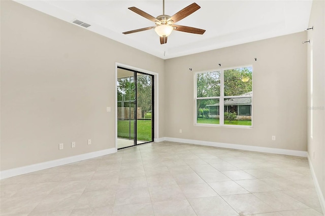 unfurnished room with plenty of natural light, ceiling fan, and light tile patterned flooring