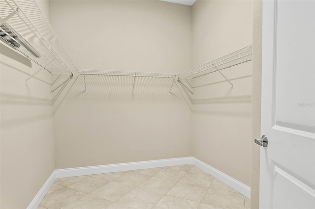 walk in closet with tile patterned flooring