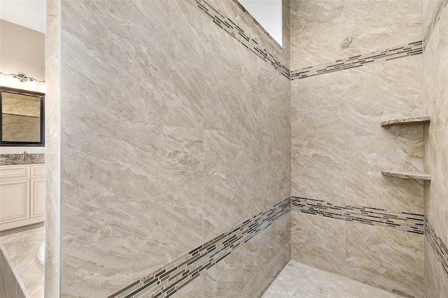 bathroom featuring vanity and a tile shower