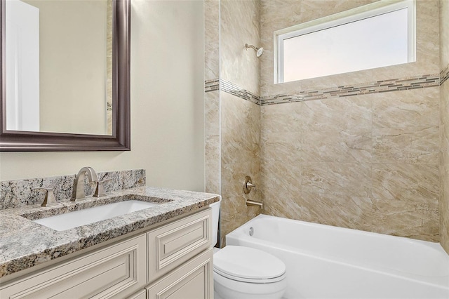 full bathroom with toilet, tiled shower / bath combo, and vanity