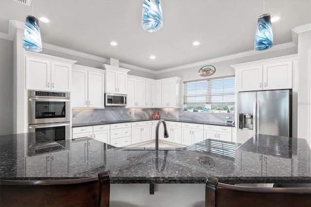 kitchen featuring decorative backsplash, a spacious island, appliances with stainless steel finishes, crown molding, and a sink