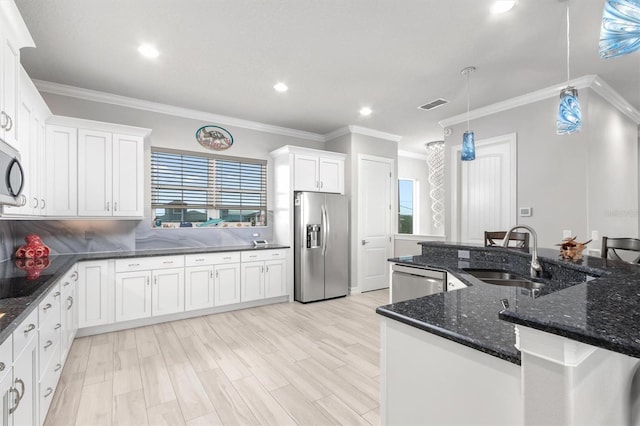 7095 N Ocean Shore Blvd, Palm Coast, FL 32137 - kitchen with appliances with stainless steel finishes, a sink, white cabinetry, ornamental molding, and pendant lighting