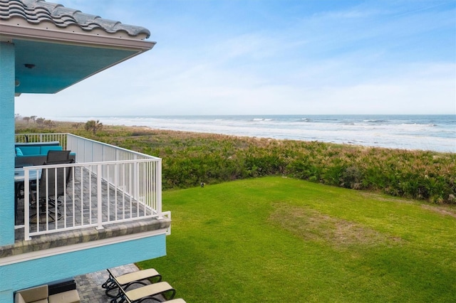 view of yard featuring a beach view and a water view