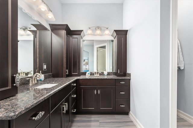 bathroom with vanity and baseboards