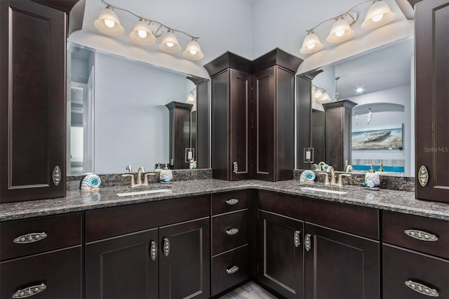 bathroom with a sink and double vanity