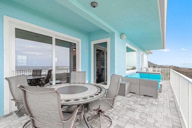 7095 N Ocean Shore Blvd, Palm Coast, FL 32137 - view of patio with outdoor dining area, an outdoor hangout area, and a balcony