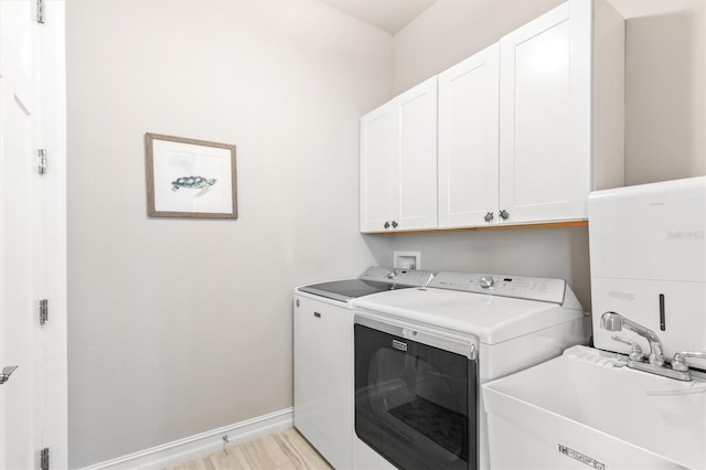 7095 N Ocean Shore Blvd, Palm Coast, FL 32137 - laundry room with cabinet space, separate washer and dryer, and baseboards