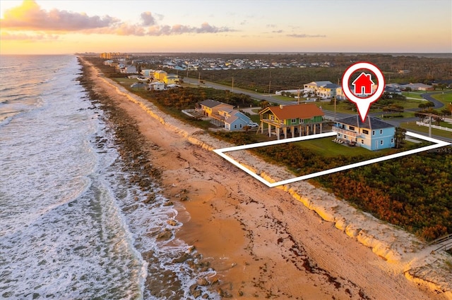 drone / aerial view featuring a water view and a view of the beach