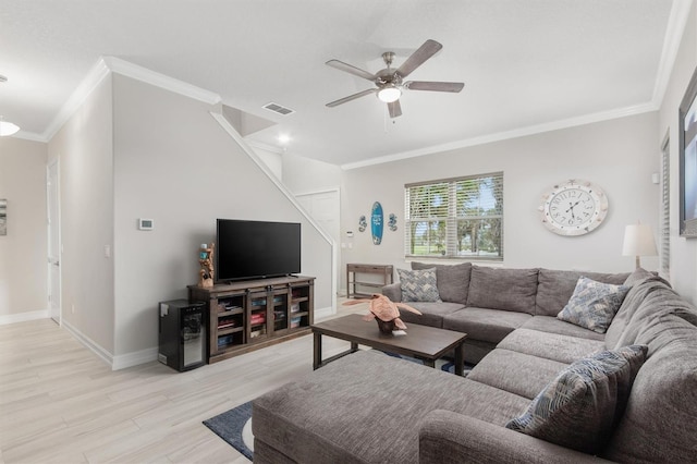 living room featuring baseboards, visible vents, a ceiling fan, light wood-style flooring, and ornamental molding