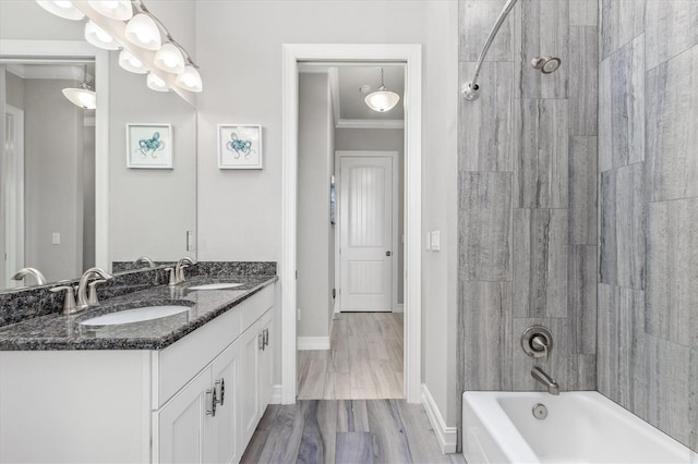 bathroom with double vanity, ornamental molding, shower / washtub combination, and a sink