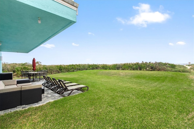 view of yard featuring outdoor dining area, a patio, and an outdoor hangout area