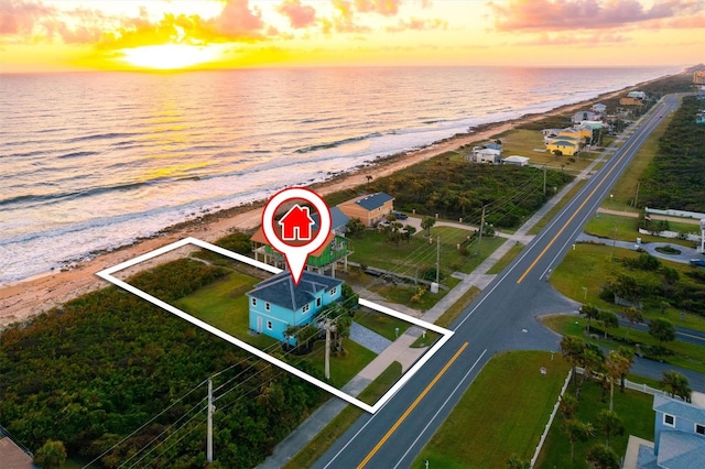 drone / aerial view with a beach view and a water view