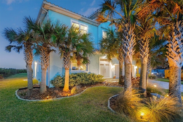 view of home's exterior featuring a lawn and stucco siding