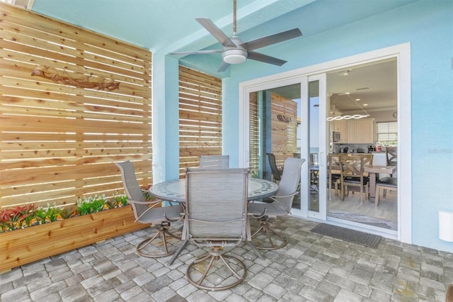 view of patio / terrace with ceiling fan and outdoor dining space