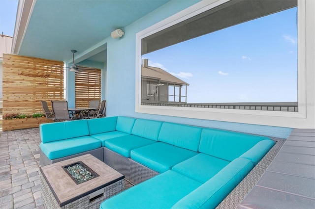 view of patio / terrace with outdoor dining area and an outdoor living space with a fire pit