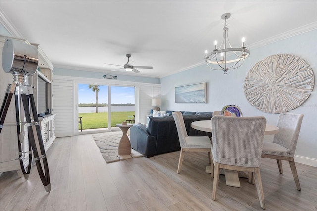 dining area featuring ornamental molding, ceiling fan with notable chandelier, and light hardwood / wood-style floors