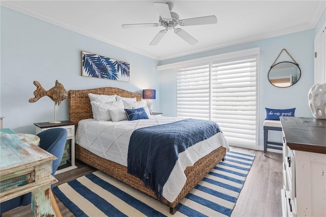 bedroom with hardwood / wood-style flooring, ceiling fan, and ornamental molding