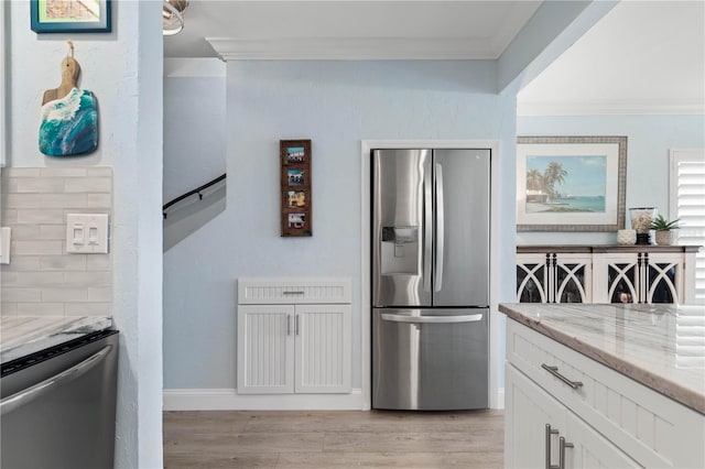 kitchen featuring white cabinetry, light stone counters, stainless steel refrigerator, and stainless steel fridge