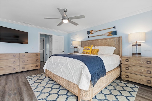 bedroom featuring ceiling fan, dark hardwood / wood-style floors, and crown molding