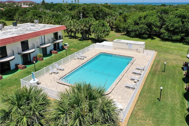 view of pool featuring a lawn and a patio area