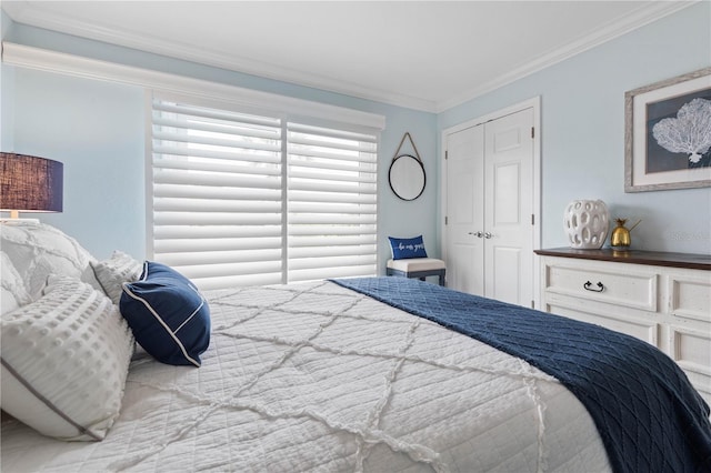 bedroom featuring a closet and crown molding