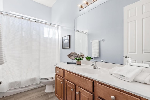 full bathroom with hardwood / wood-style flooring, vanity, toilet, and shower / bath combination with curtain