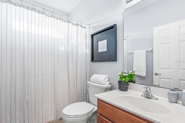 bathroom with walk in shower, vanity, and toilet