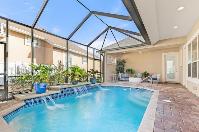 view of swimming pool featuring a patio, glass enclosure, and pool water feature