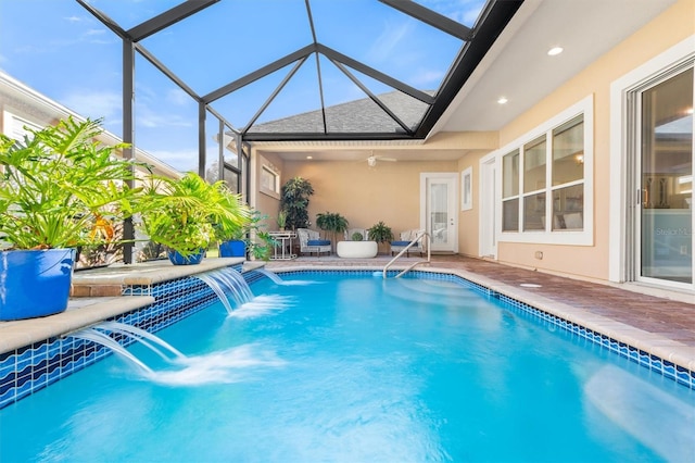 view of pool with a lanai, a patio, ceiling fan, and pool water feature