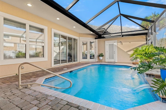 view of swimming pool featuring a patio, glass enclosure, and pool water feature