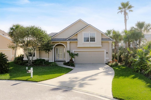 view of front of property featuring a garage and a front yard