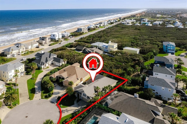 drone / aerial view with a water view and a beach view