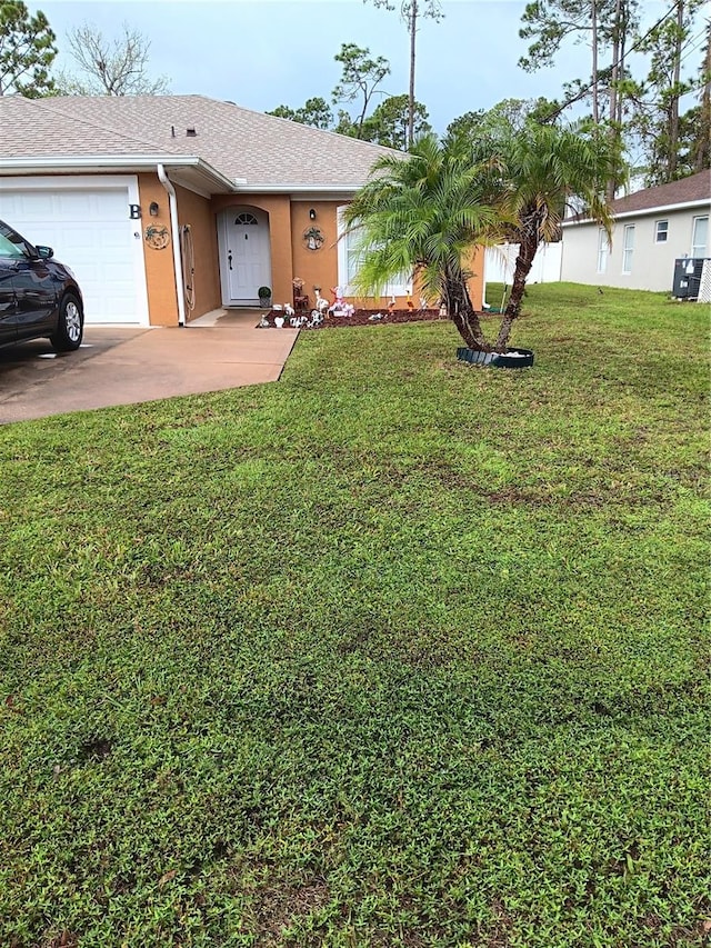 view of front of home with a garage and a front yard