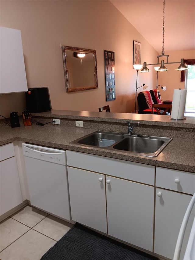 kitchen with vaulted ceiling, sink, white dishwasher, hanging light fixtures, and white cabinets