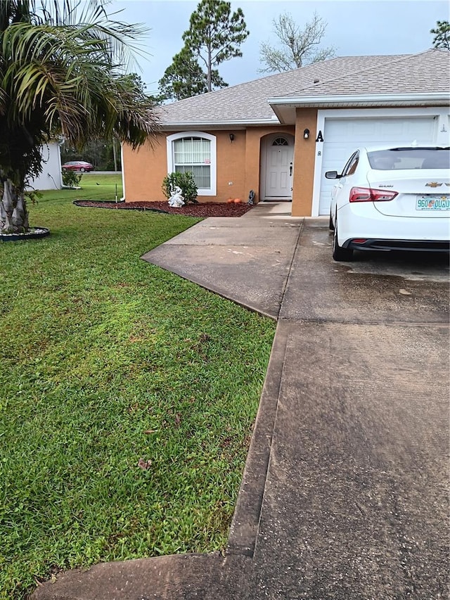 ranch-style house featuring a front lawn and a garage