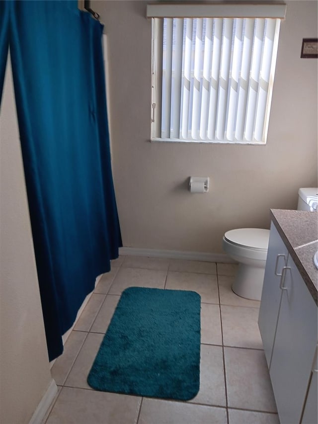 bathroom featuring toilet, vanity, and tile patterned floors