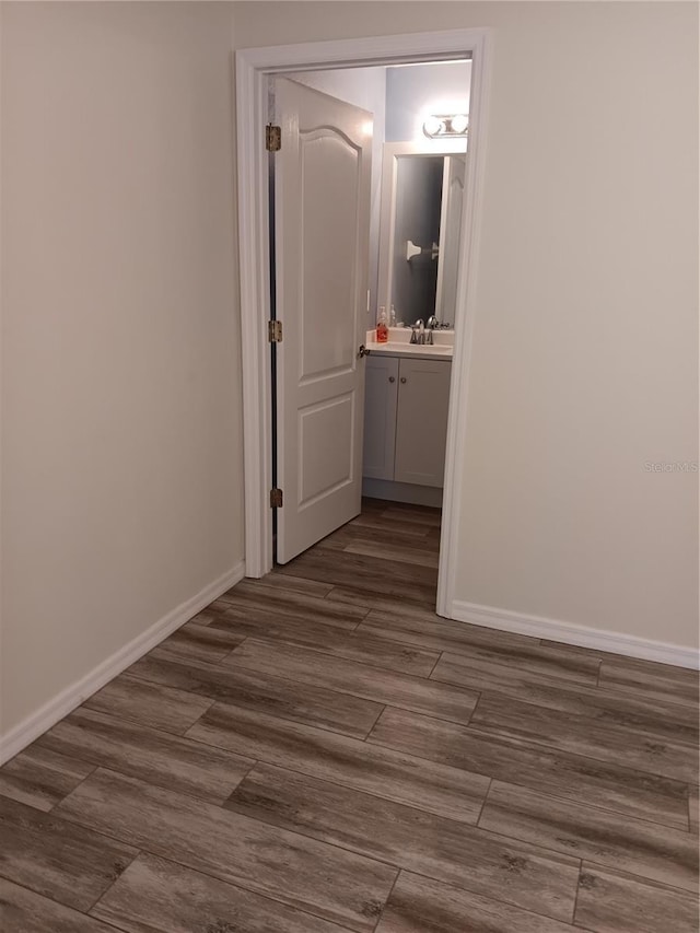 hall with dark wood-type flooring and sink