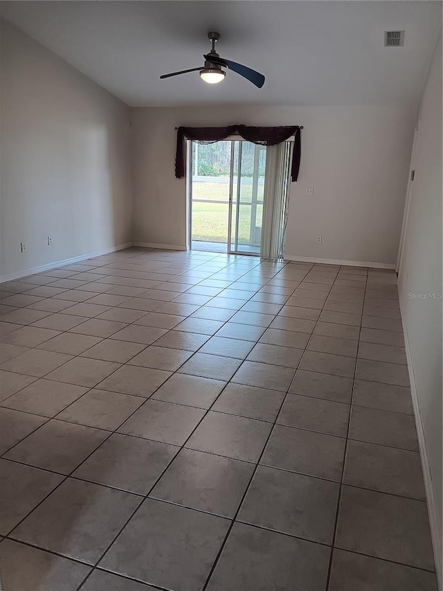 empty room with ceiling fan and light tile patterned floors