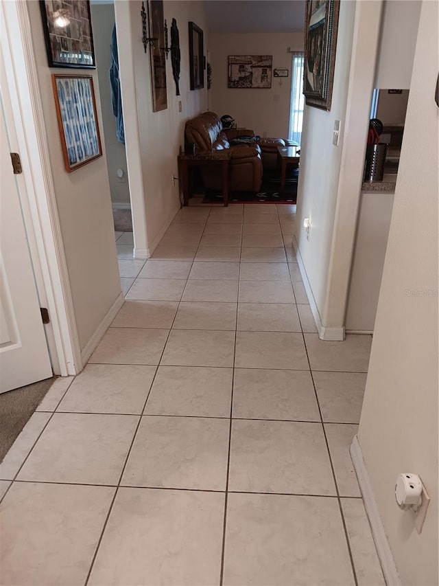 hall with light tile patterned floors