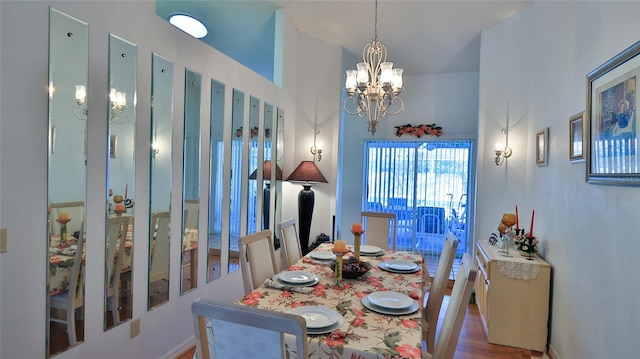 dining area with hardwood / wood-style flooring and a notable chandelier