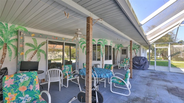 sunroom with ceiling fan and lofted ceiling with skylight